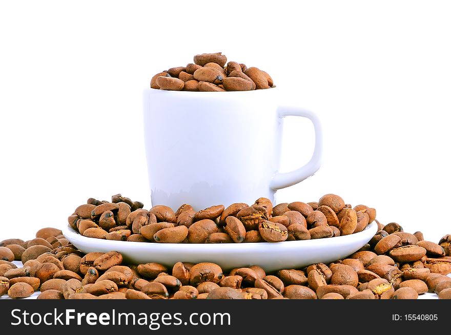 White cup filled with coffee beans isolated