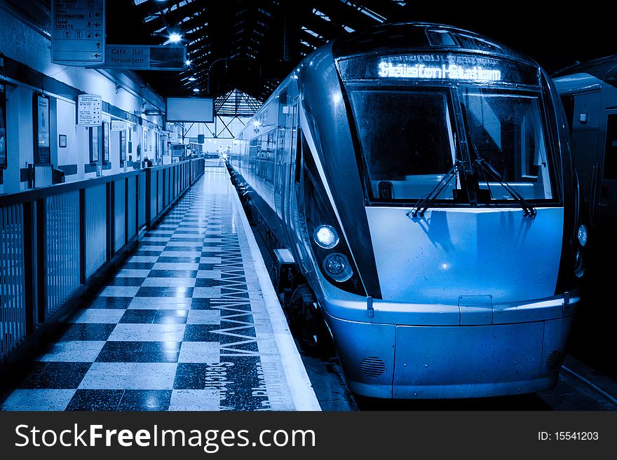 Passenger train inside the station, monochromatic