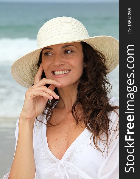 Closeup of beautiful woman wearing straw hat. Closeup of beautiful woman wearing straw hat