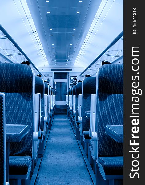 Modern railway coach interior illuminated and row of seats, monochromatic. Modern railway coach interior illuminated and row of seats, monochromatic