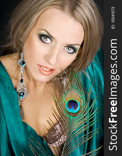 Fashionable woman with peacock feather