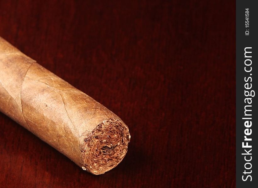 Detailed closeup of a hand rolled cigar and copy space. Detailed closeup of a hand rolled cigar and copy space