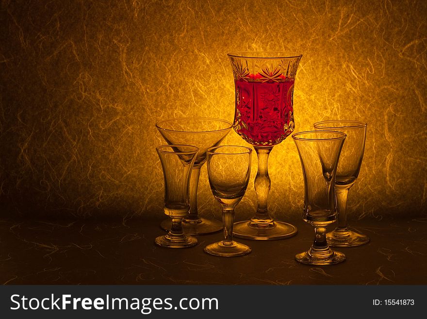 Red wine and glass on brown background