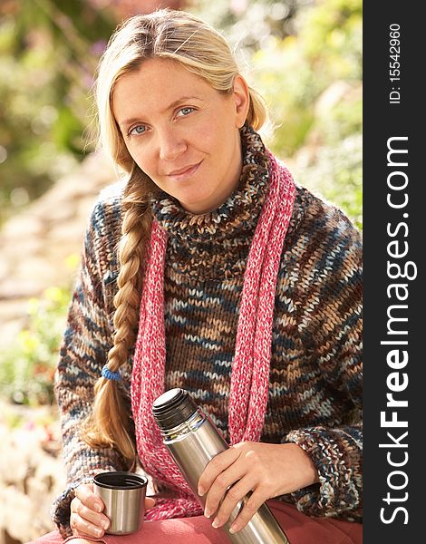 Young Woman Relaxing With Thermos Flask