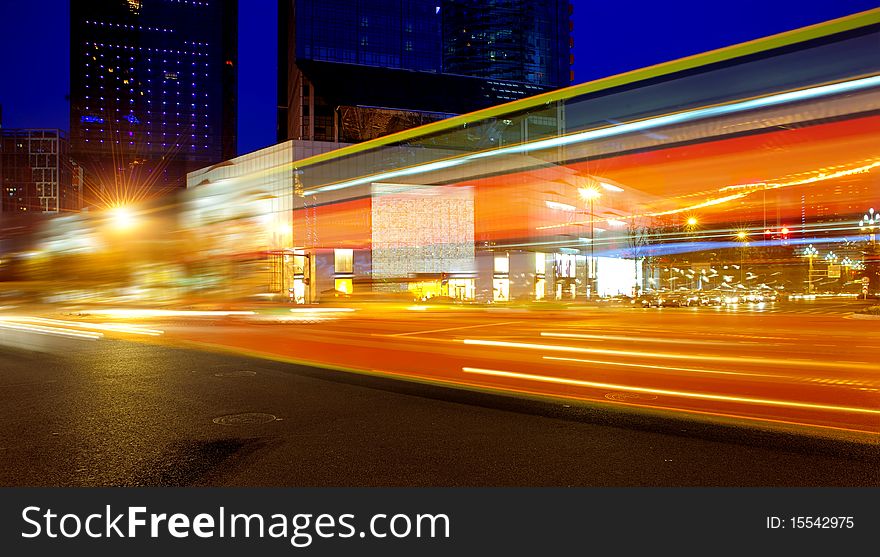 High speed and blurred bus light trails in downtown nightscape