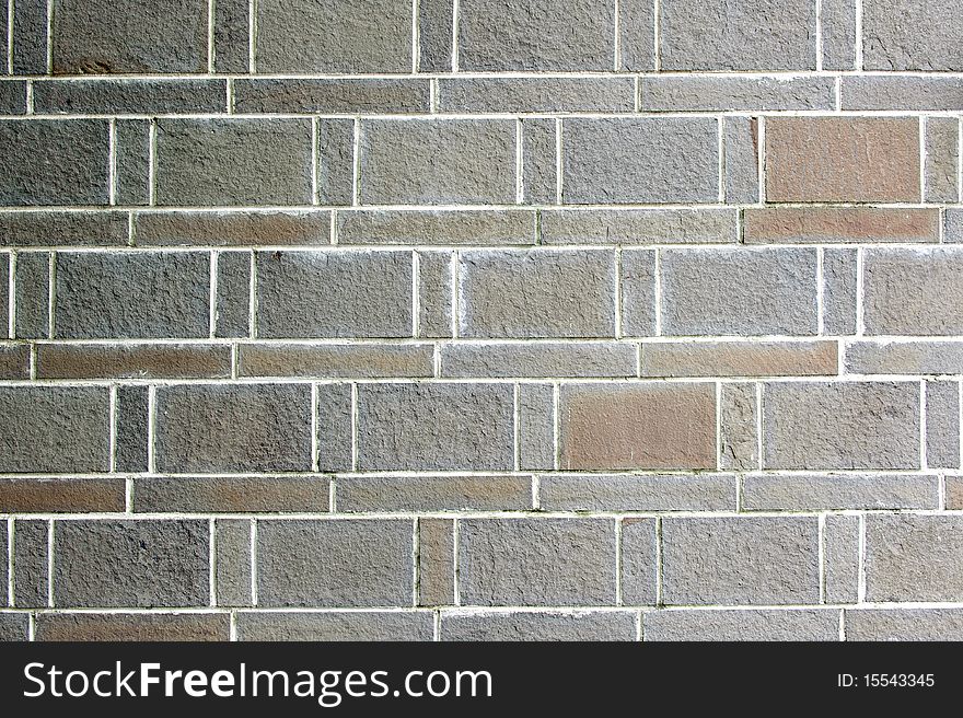 A orderly  sandstone brick wall.