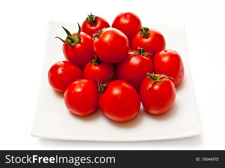 Tomatoes on white plate. Isolated on white background