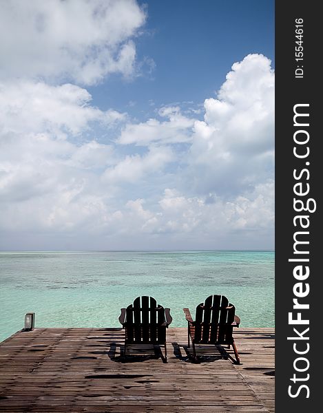 A pair of chair in front of beach. A pair of chair in front of beach