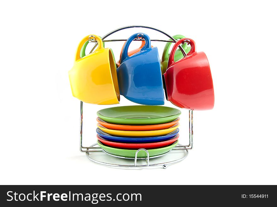 Studio shot of the multi colored cups hanging on the holder. Studio shot of the multi colored cups hanging on the holder