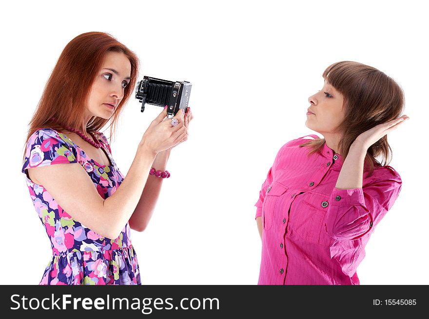 Two beautiful girls to pose and take pictures on white background