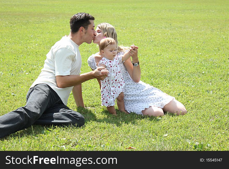 Happy family on the green grass