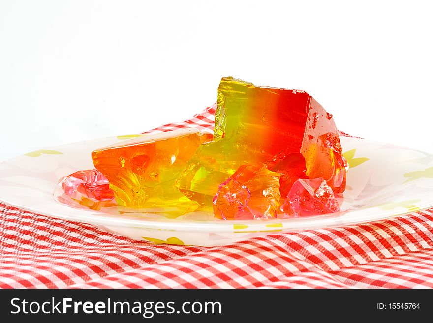 Fruit jelly on a plate on a white background