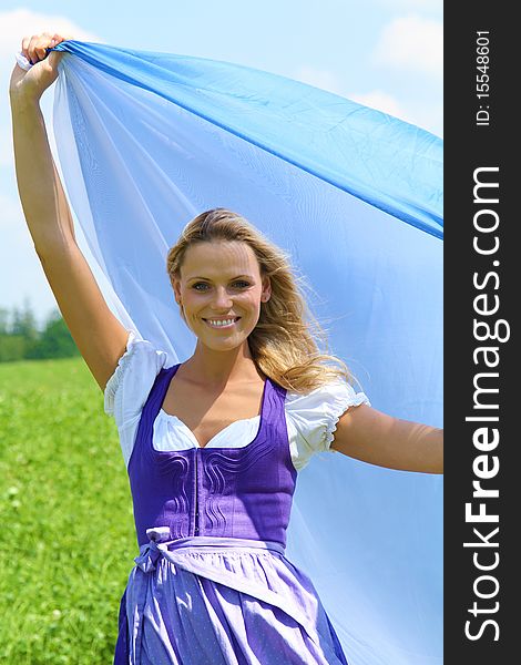 Blond bavarian Girl playing with the wind