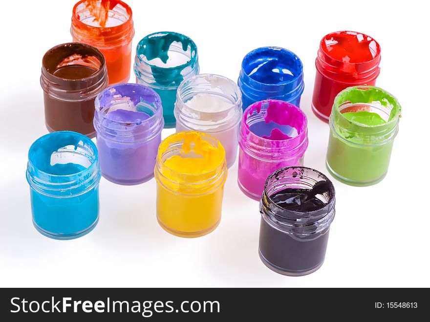 Watercolour pain in jars spilled on white background