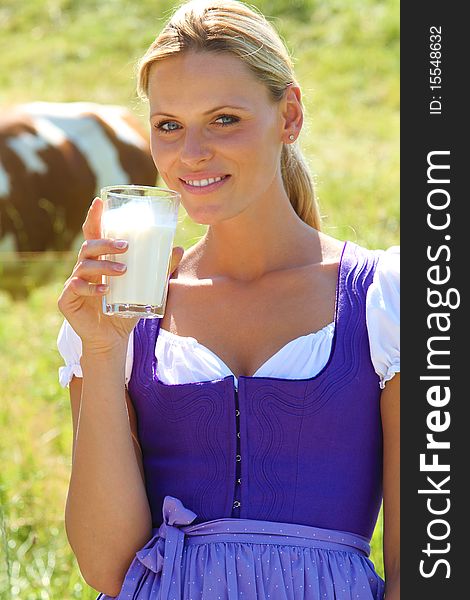 Blond bavarian Girl drinking a glas of milk. Blond bavarian Girl drinking a glas of milk