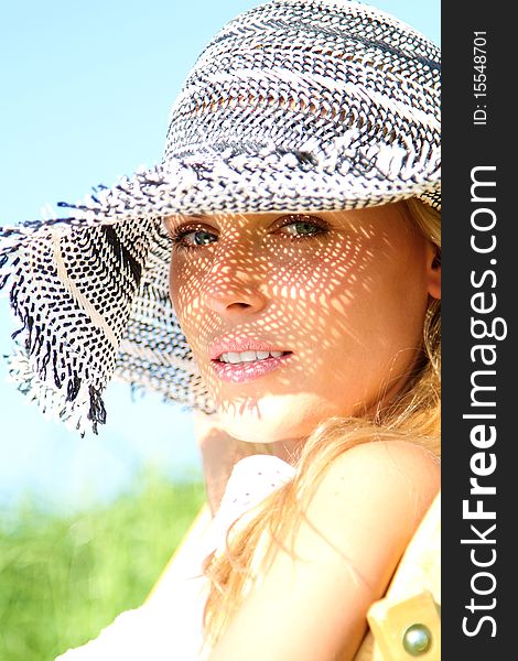 Beautiful blond girl with a sunhat