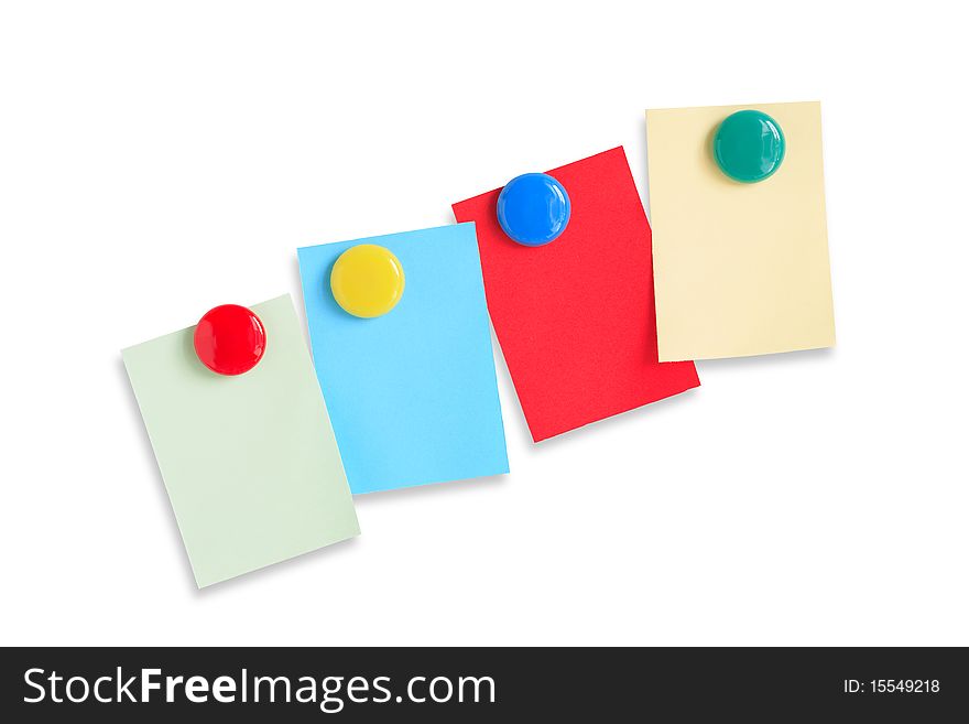 Few colored paper sheets hanging with magnets on white background. Clipping path included. Few colored paper sheets hanging with magnets on white background. Clipping path included