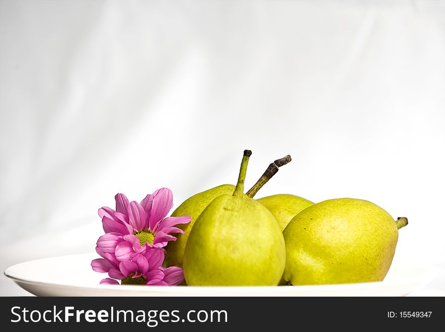 3 green pear and flower on plate