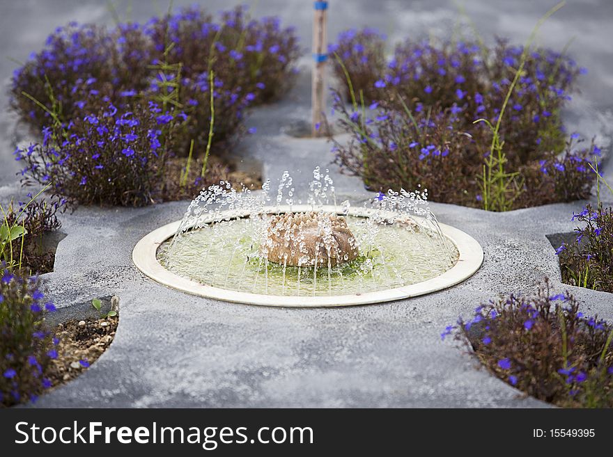 A miniature of fountains with flowers and plants. A miniature of fountains with flowers and plants