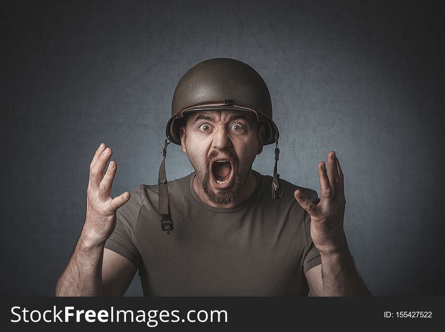 Portrait of a screaming soldier with open arms