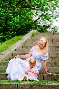 Woman And Her Baby Daughter Sit On A Stone Steps Royalty Free Stock Photography Woman And Her Baby Daughter Sit On A Stone Steps Royalty Free Stock Photography