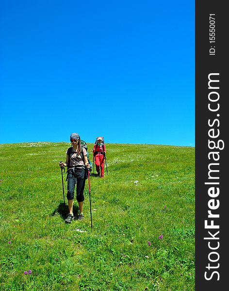 Two girls with backpacks walking outdoor. Two girls with backpacks walking outdoor