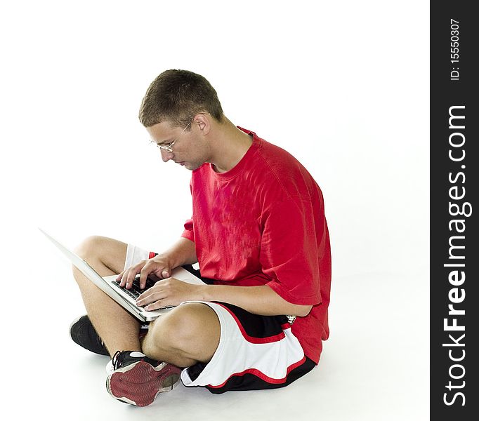 Young man, teenager with red shirt working on laptop, isolated on white background. Young man, teenager with red shirt working on laptop, isolated on white background