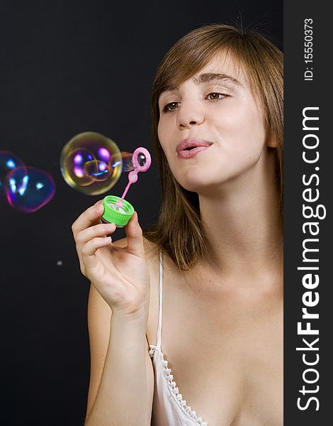 Young woman playing with bubbles. Young woman playing with bubbles