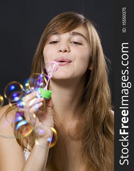Young woman playing with bubbles. Young woman playing with bubbles