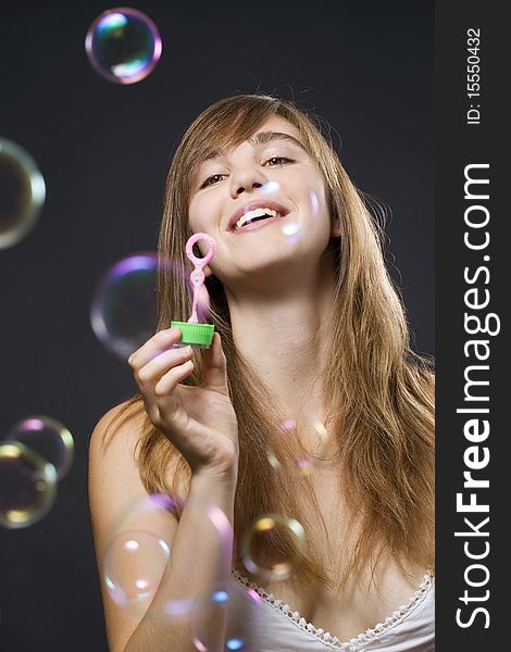 Young woman playing with bubbles. Young woman playing with bubbles