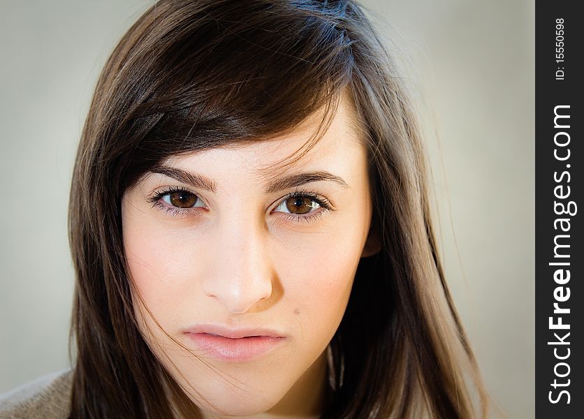 A pretty young woman stares seductively and directly into the camera.