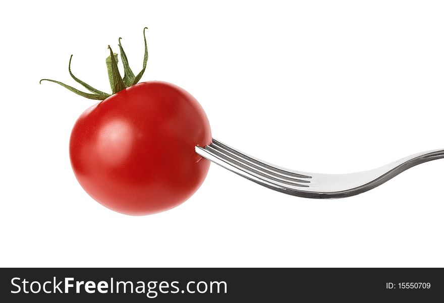 Fresh diet red tomato snack on silver fork. Fresh diet red tomato snack on silver fork