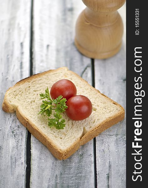 Aranged food two tomatoe on toast, on wooden background