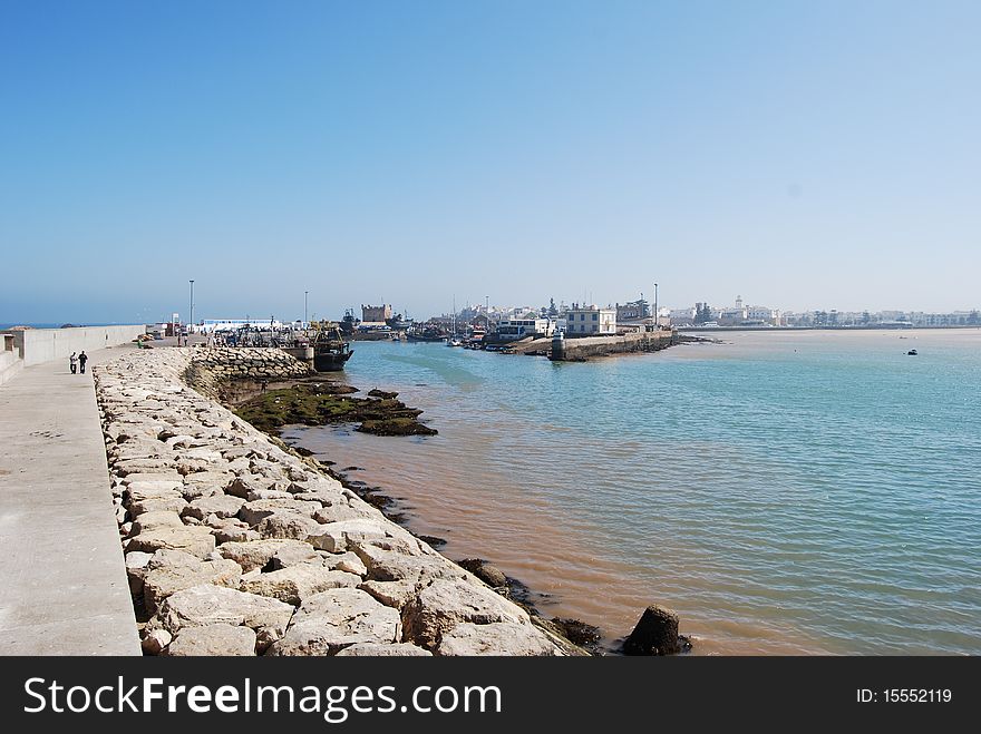 The long harbour wall at the Atlantic coastal fishing port of Essaouira in Morocco