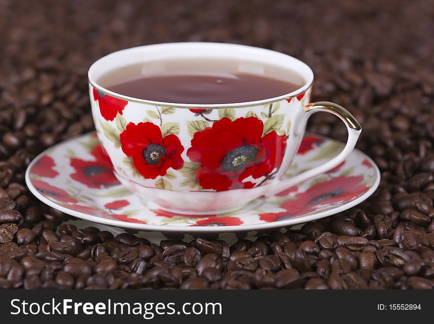 Delicate cup and saucer on coffee beans. Delicate cup and saucer on coffee beans