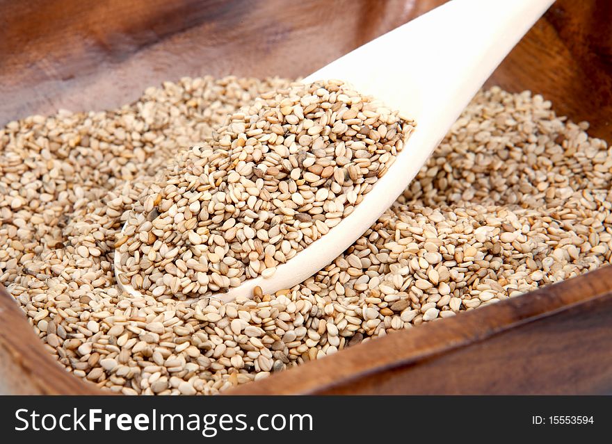 Sesame seeds in a brown bowl. Sesame seeds in a brown bowl