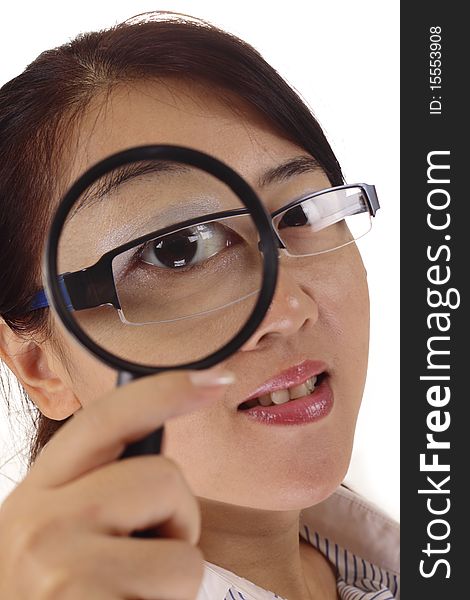 An Asian woman using a magnifying glass. An Asian woman using a magnifying glass