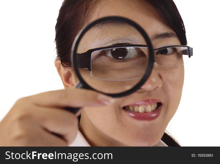 An Asian woman using a magnifying glass. An Asian woman using a magnifying glass