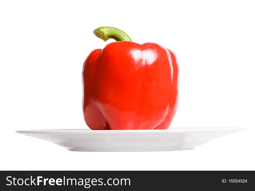 Red paprika on white plate. Isolated oh white background