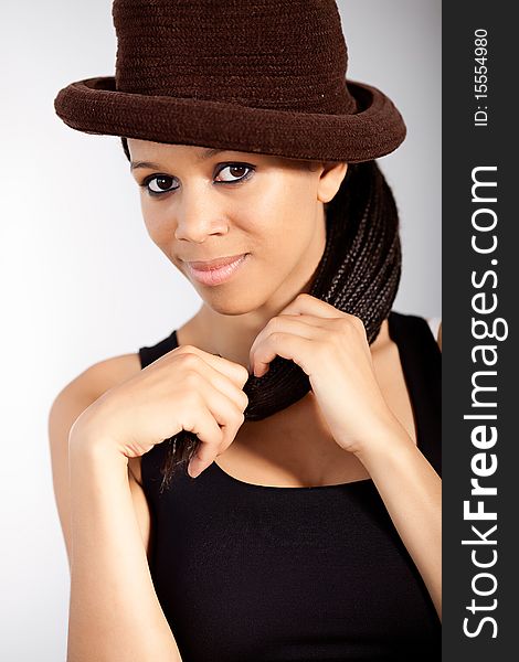 Black and white portrait of a beautiful afro american model wearing a hat. Black and white portrait of a beautiful afro american model wearing a hat