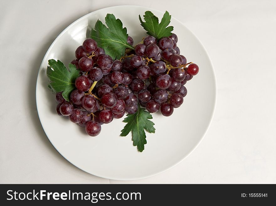 Red grape on white plate