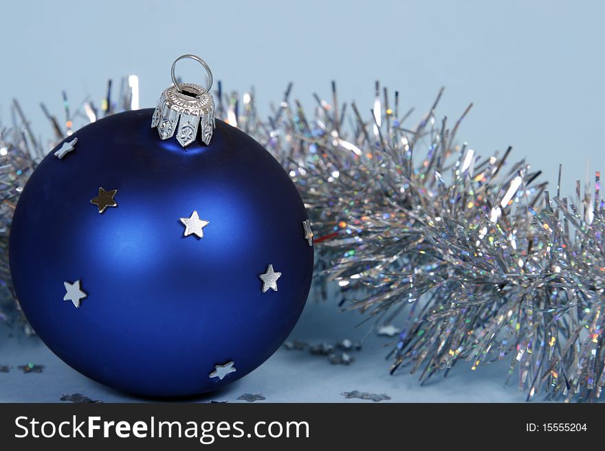 Blue christmas ball on the blue background. Blue christmas ball on the blue background