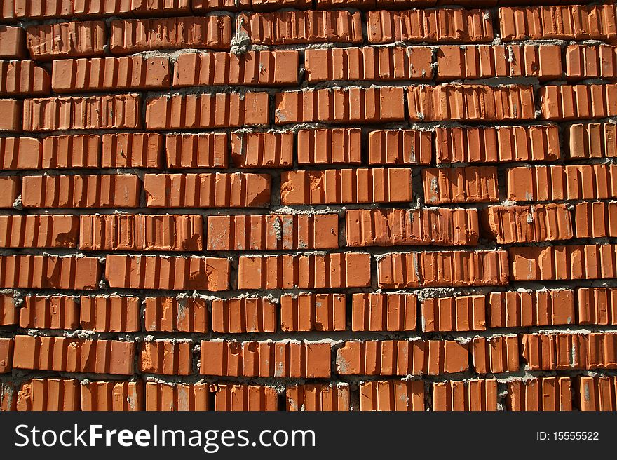 The red brick wall of a house, can be used as background. The red brick wall of a house, can be used as background