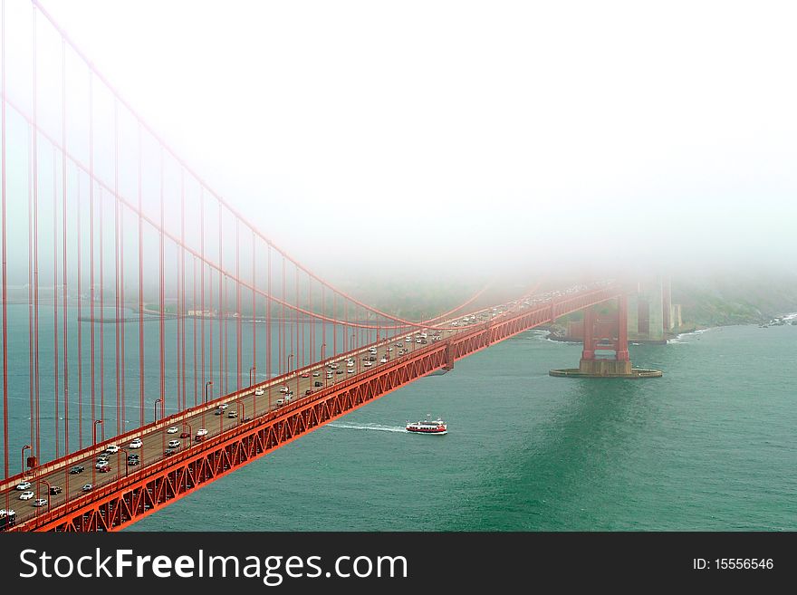 A ferry going under the Golden Gate Bridge on an unusually foggy day. A ferry going under the Golden Gate Bridge on an unusually foggy day.