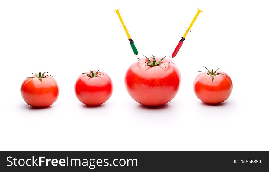 Injecting liquid in big tomato. Useful for genetic modification concepts. Injecting liquid in big tomato. Useful for genetic modification concepts.