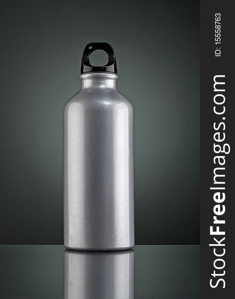 Shiny grey thermos taken in studio with lighting set-up. 3 lightings were used, with 2 side lightings and 1 background light