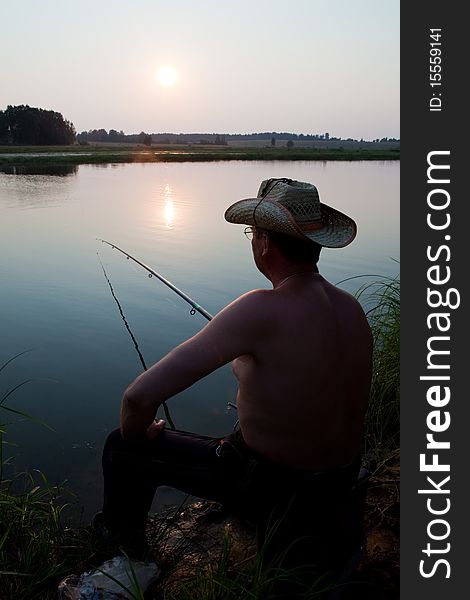 Man fishes in the river on a fishing tackle