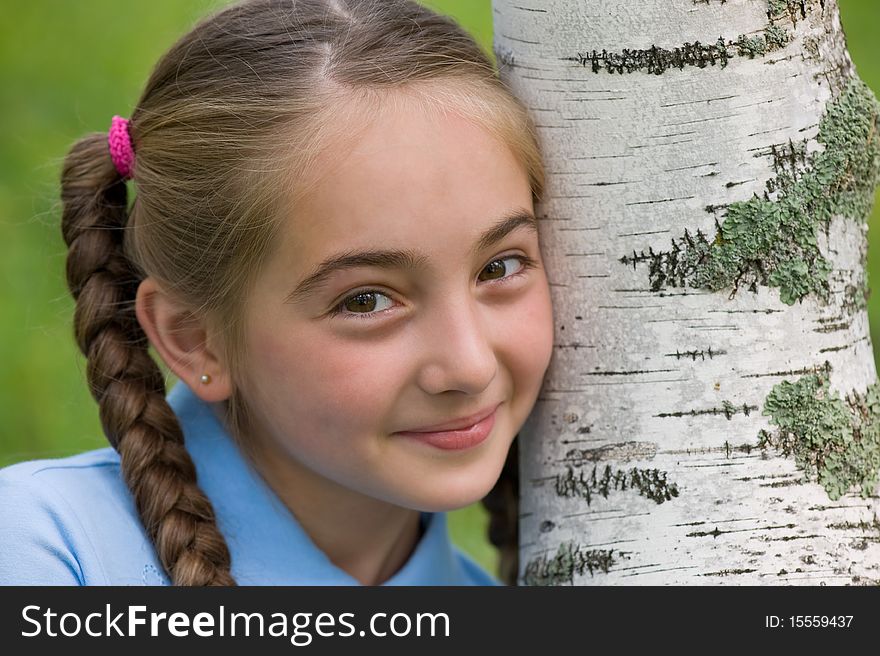 The girl has leaned a head against a birch. The girl has leaned a head against a birch