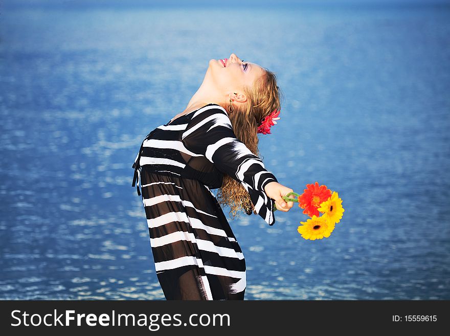 Beautiful woman with flowers in the sea. Beautiful woman with flowers in the sea