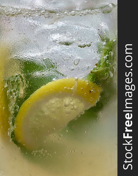 Close up of alcohol drinks with lemon slice and ice. Close up of alcohol drinks with lemon slice and ice